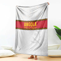 Angola football blanket draped on floor, white with red stripe and yellow trim