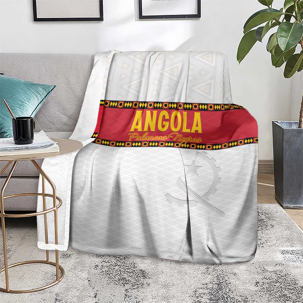 Angola football blanket on living room floor, white with red band and star graphic