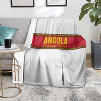 Angola football blanket on living room floor, white with red band and star graphic