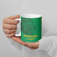 Green ceramic mug with lion head artwork and gold “MAURITlANA” text