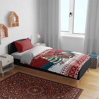 Red Christmas bedding set on bed with duvet and pillows featuring moose holiday graphic