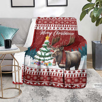 Red Christmas blanket with reindeer image on sofa, festive stripes and 'Merry Christmoose'