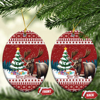 Red ceramic oval Christmas ornament with reindeer and Christmas tree scene, gold hanger