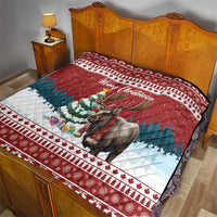 Red Christmas quilt on a bed, 'Merry Christmoose' text over moose and winter scenes