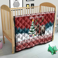 Red Christmas quilt on a crib with 'Merry Christmoose' text and moose graphic