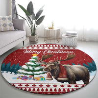 Round Christmas rug with moose artwork, Merry Christmoose script, snowy scene, and trees