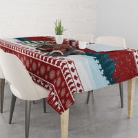 Red and teal Christmas tablecloth with pine tree and snowflake motifs