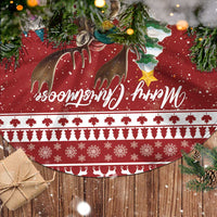 Red tree skirt with deer, snowflake patterns, festive lettering, and white trim