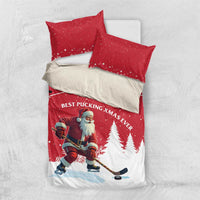 Red Christmas bedding set flat lay with Santa hockey player, pine trees, crescent moon, two pillowcases