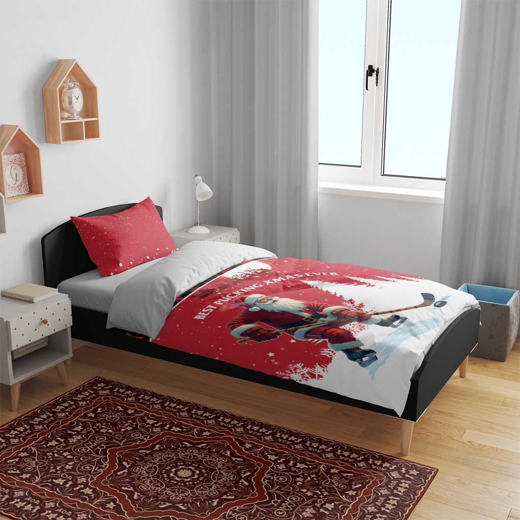 Red Christmas bedding set on bed with Santa hockey player, pine trees, crescent moon motif and pillow