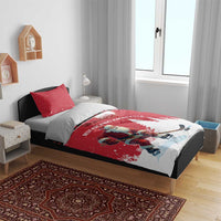 Red Christmas bedding set on bed with Santa hockey player, pine trees, crescent moon motif and pillow