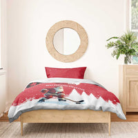 Red Christmas bedding set on bed with Santa hockey player, pine trees and crescent moon, one pillow