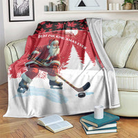 Red Christmas blanket with Santa hockey player, pine trees, and maple leaf border