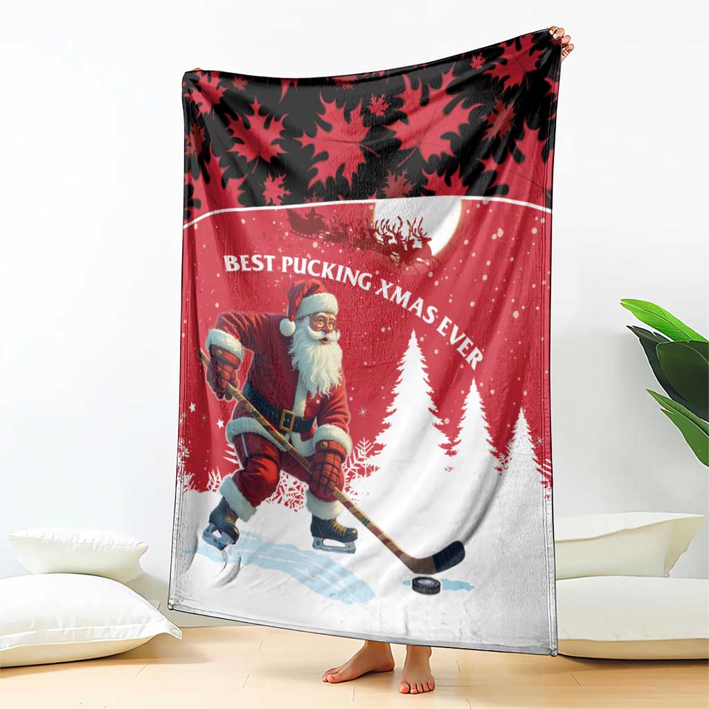 Red and white blanket showing Santa hockey player with pine trees and maple leaf pattern