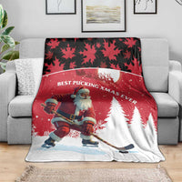 Red Christmas blanket draped on a sofa with Santa hockey player and pine tree print