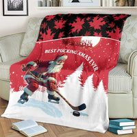 Red and white Christmas blanket featuring Santa hockey player, pine trees, and maple leaves