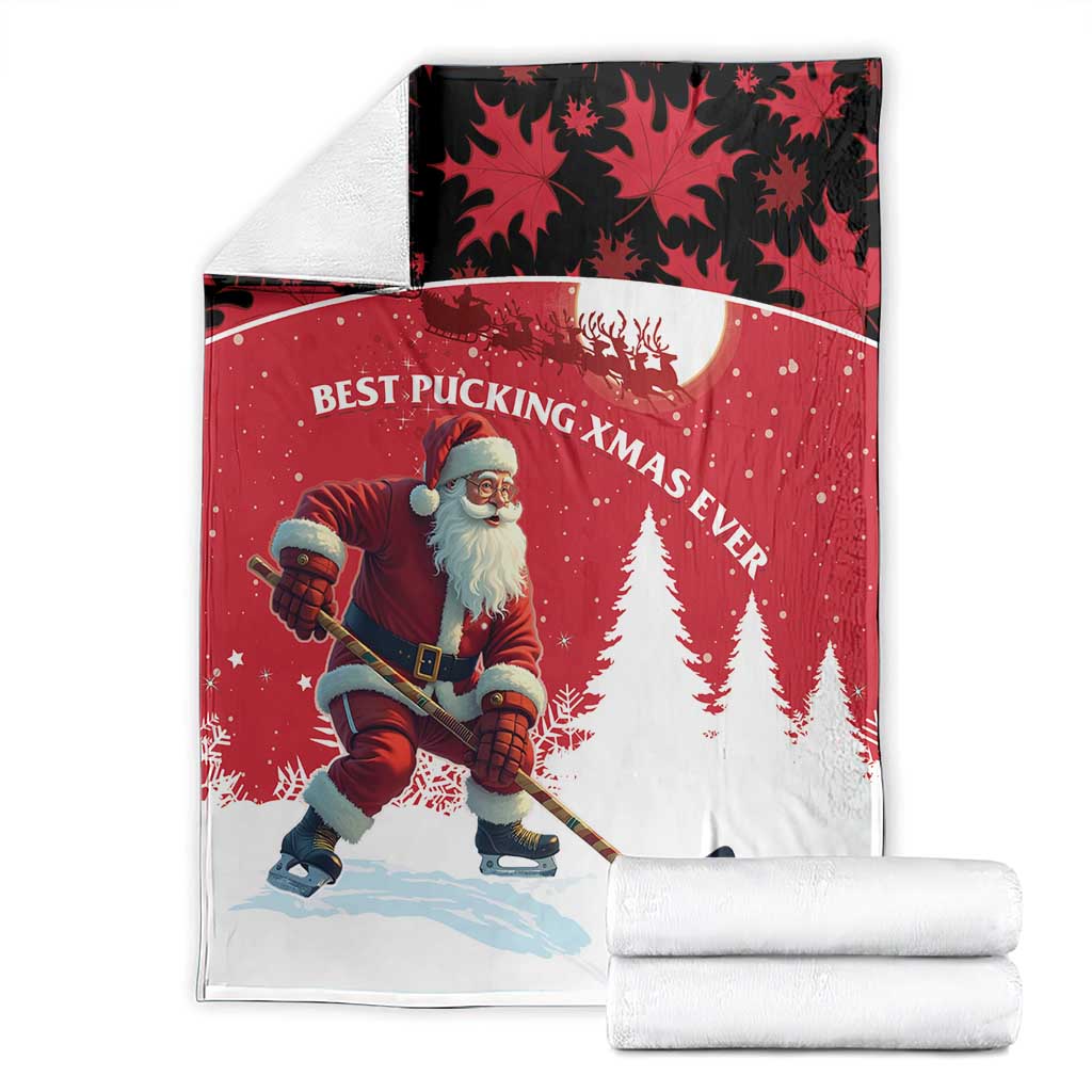 Folded red Christmas blanket with Santa hockey player, pine trees, and maple leaf motif