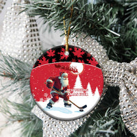 Personalized red Santa hockey ceramic ornament, circle shape hanging on a tree