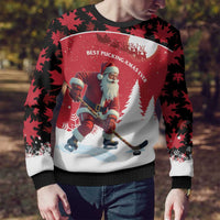 Red and black ugly Christmas sweater close-up with Santa hockey player and snowy landscape graphic