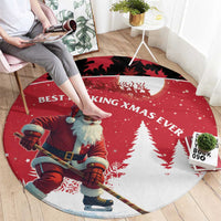 Red round Christmas carpet showing Santa hockey player, pine trees, and 'Best Pucking Xmas Ever'