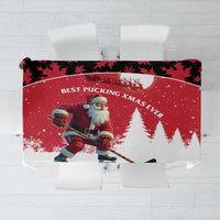 Red Christmas tablecloth with Santa hockey player and maple leaf pattern, folded view