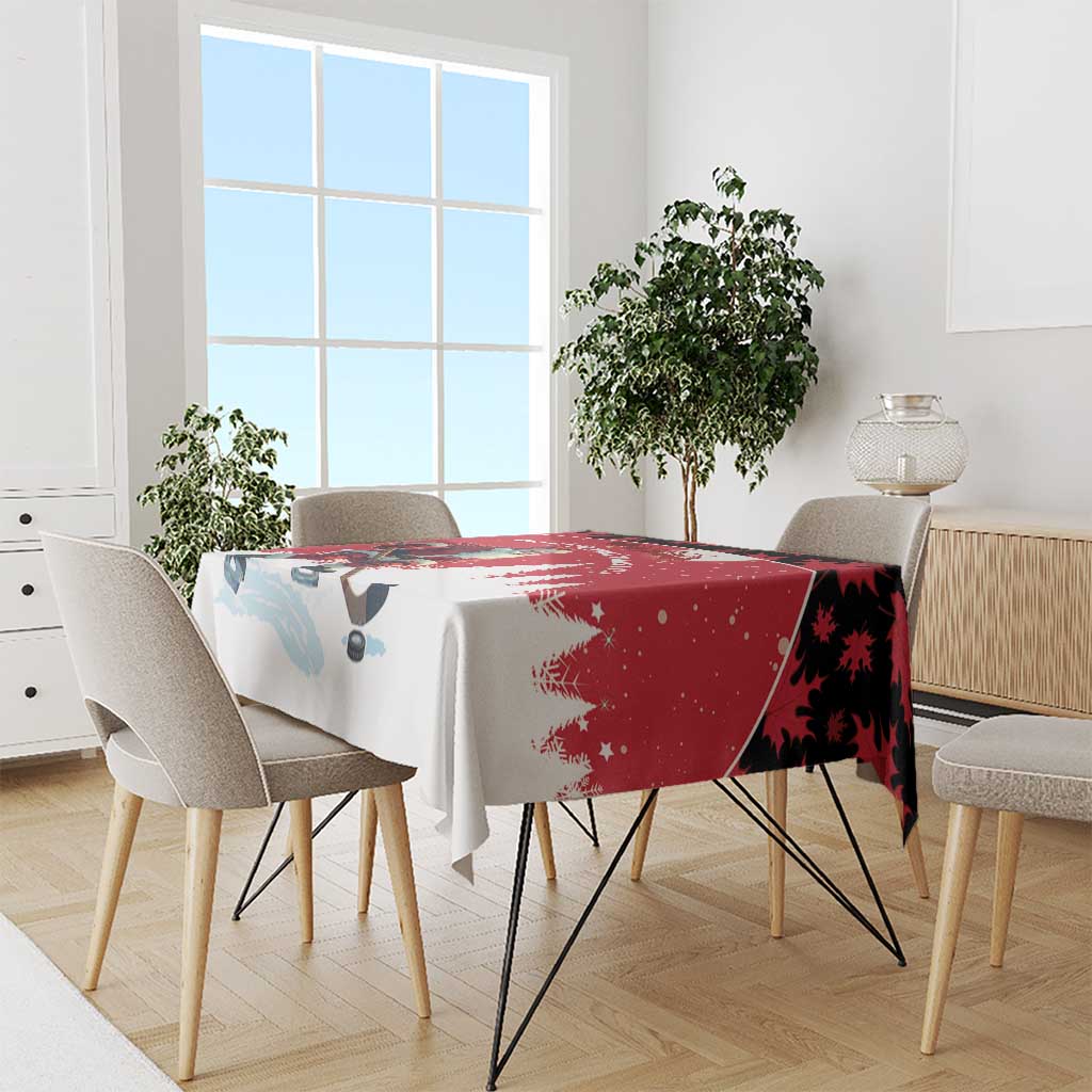 Red and white tablecloth draped over dining table with Santa hockey player motif