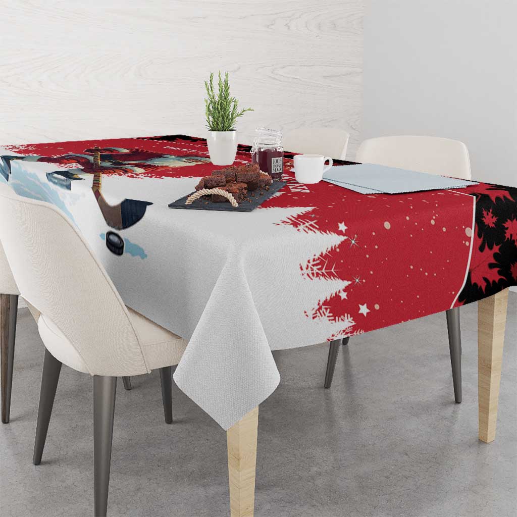 Red and white tablecloth over dining table with Santa, pine trees, and snowflake accents