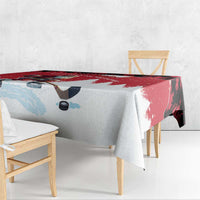 Red and white Christmas tablecloth corner close-up with Santa and pine tree accents