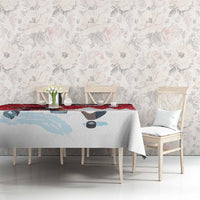 Red and light blue winter-themed tablecloth with hockey player silhouette on dining set