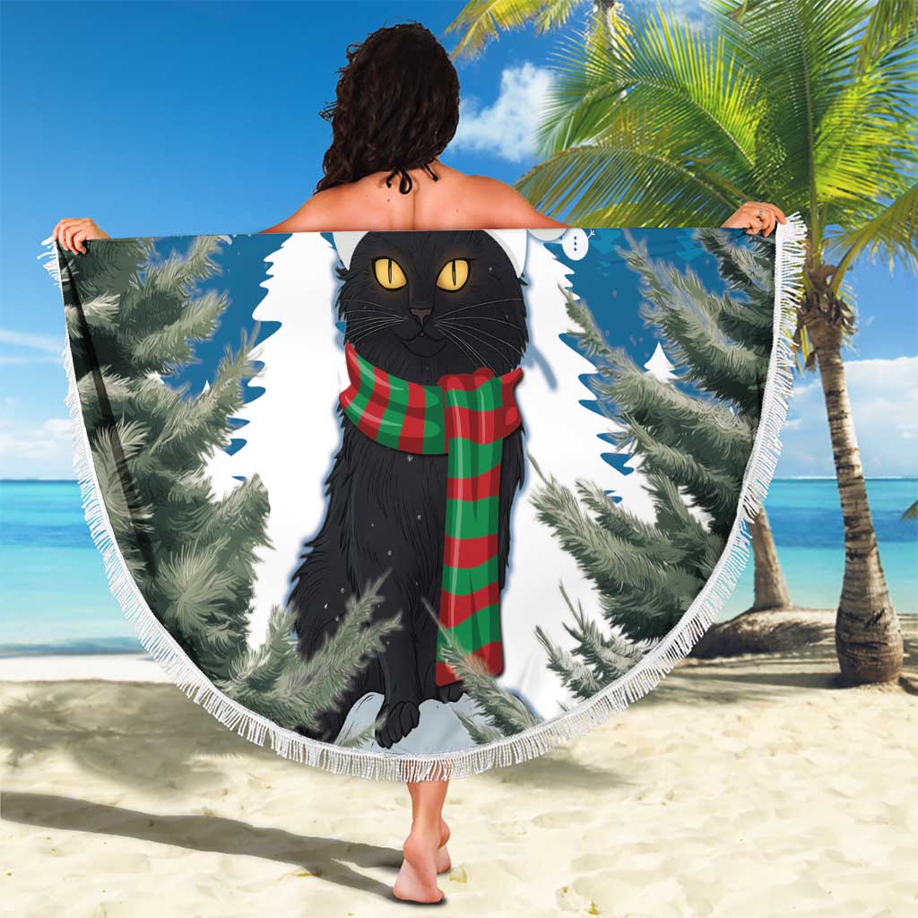 Round beach blanket held up, blue with white fringe; black cat wearing Santa hat and scarf