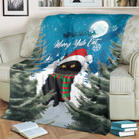 Blue Christmas blanket showing black cat in red hat and plaid scarf under moon