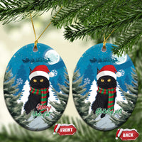 Two blue oval ceramic ornaments with black cat in Santa hat and red plaid scarf