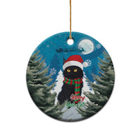 Blue round ceramic ornament featuring a black cat wearing a Santa hat and red plaid scarf