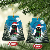 Blue Christmas ornament shaped like a tree, with cat in Santa hat and red plaid scarf