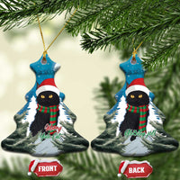 Blue Christmas ornament shaped like a tree, showing a cat in Santa hat and plaid scarf