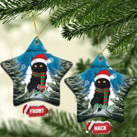 Two blue star-shaped ceramic ornaments with a black cat in Santa hat and plaid scarf