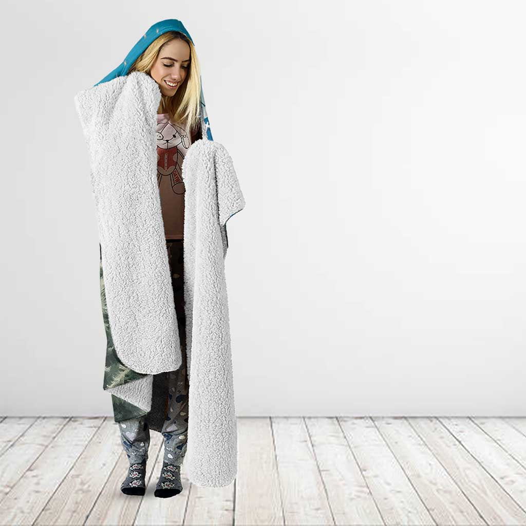 Blue hooded Christmas blanket worn by woman; long blanket with sherpa-style hood lining