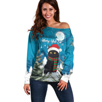 Blue off-shoulder sweater with holiday cat graphic, long sleeves, festive winter print