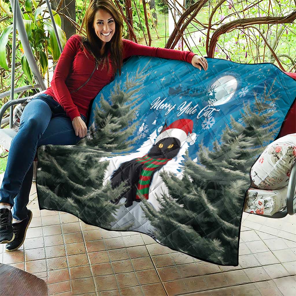 Blue quilt blanket with black cat in holiday scarf, pine trees, moon, and Merry Yule Cat.