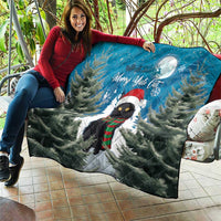 Blue quilt blanket with black cat in holiday scarf, pine trees, moon, and Merry Yule Cat.