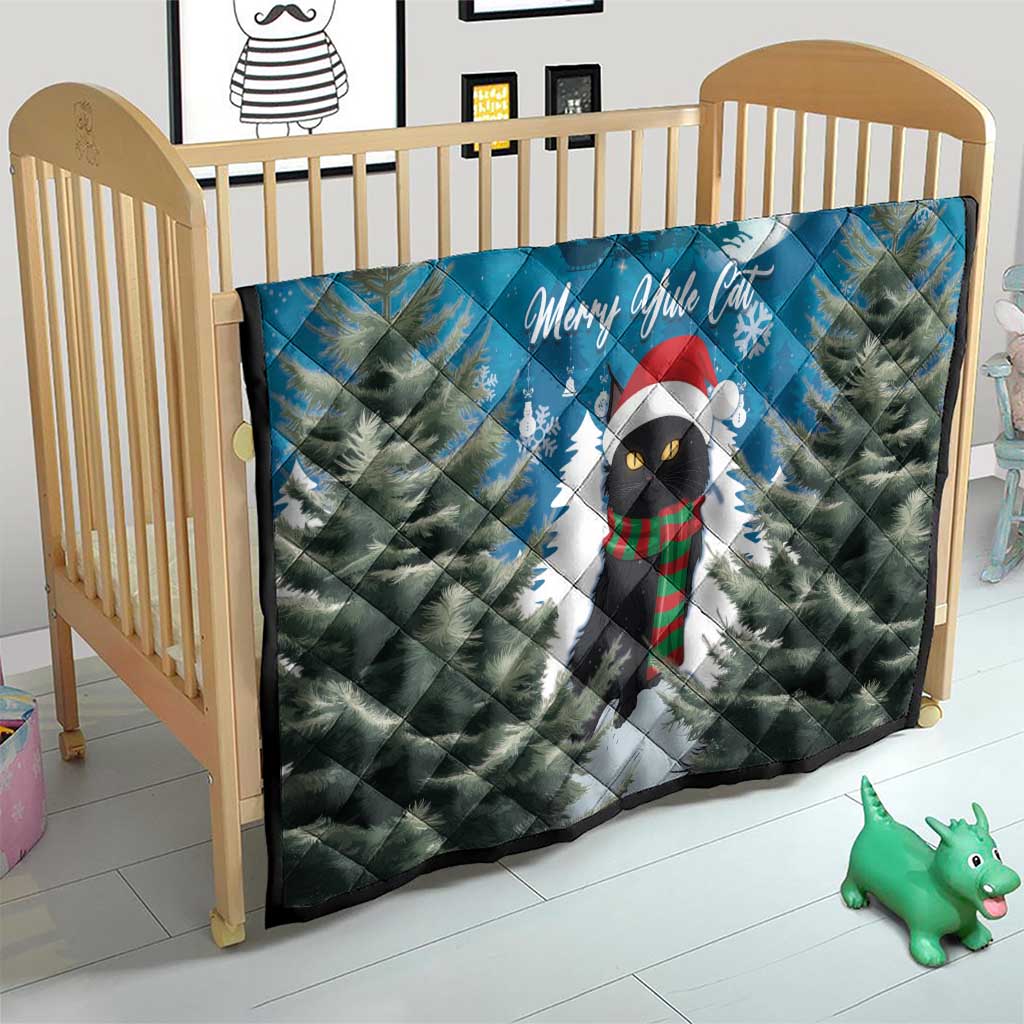 Blue quilt on a baby bed: cat in Santa hat with pine trees, moon, and Merry Yule Cat text.