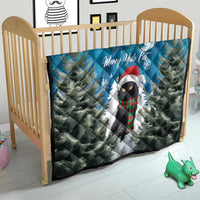 Blue quilt on a baby bed: cat in Santa hat with pine trees, moon, and Merry Yule Cat text.