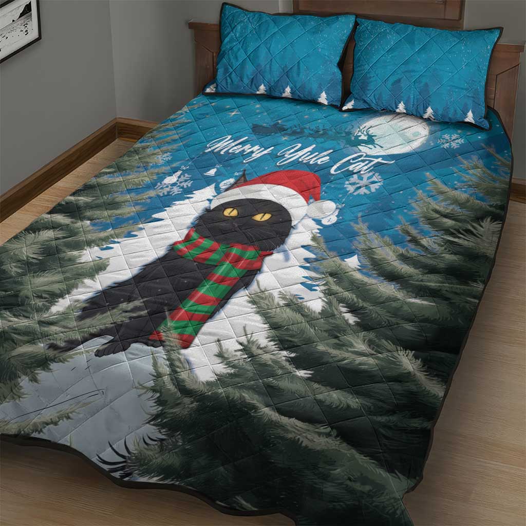 Blue quilt bed set with cat wearing red scarf, pine trees, and Merry Yule text