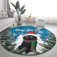 Blue round rug with centered black cat wearing red hat and green plaid scarf graphic