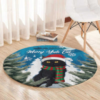 Blue circular rug showing black cat in red Santa hat and green plaid scarf with 'Merry Ayule Cat'
