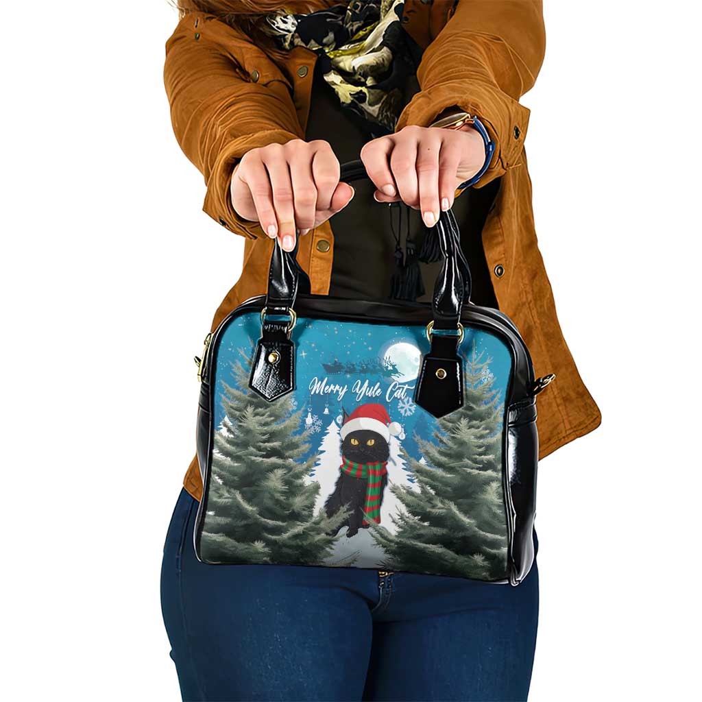 Blue and black shoulder handbag with festive cat, trees print and two top handles.