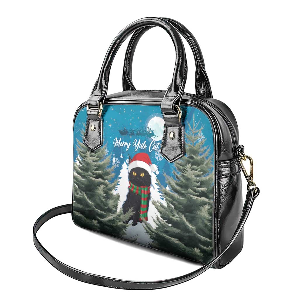 Blue top-handle handbag with black trim, crossbody strap, and festive cat trees print.