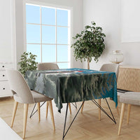 Blue holiday tablecloth with fir-tree and snowflake pattern, draped over dining table