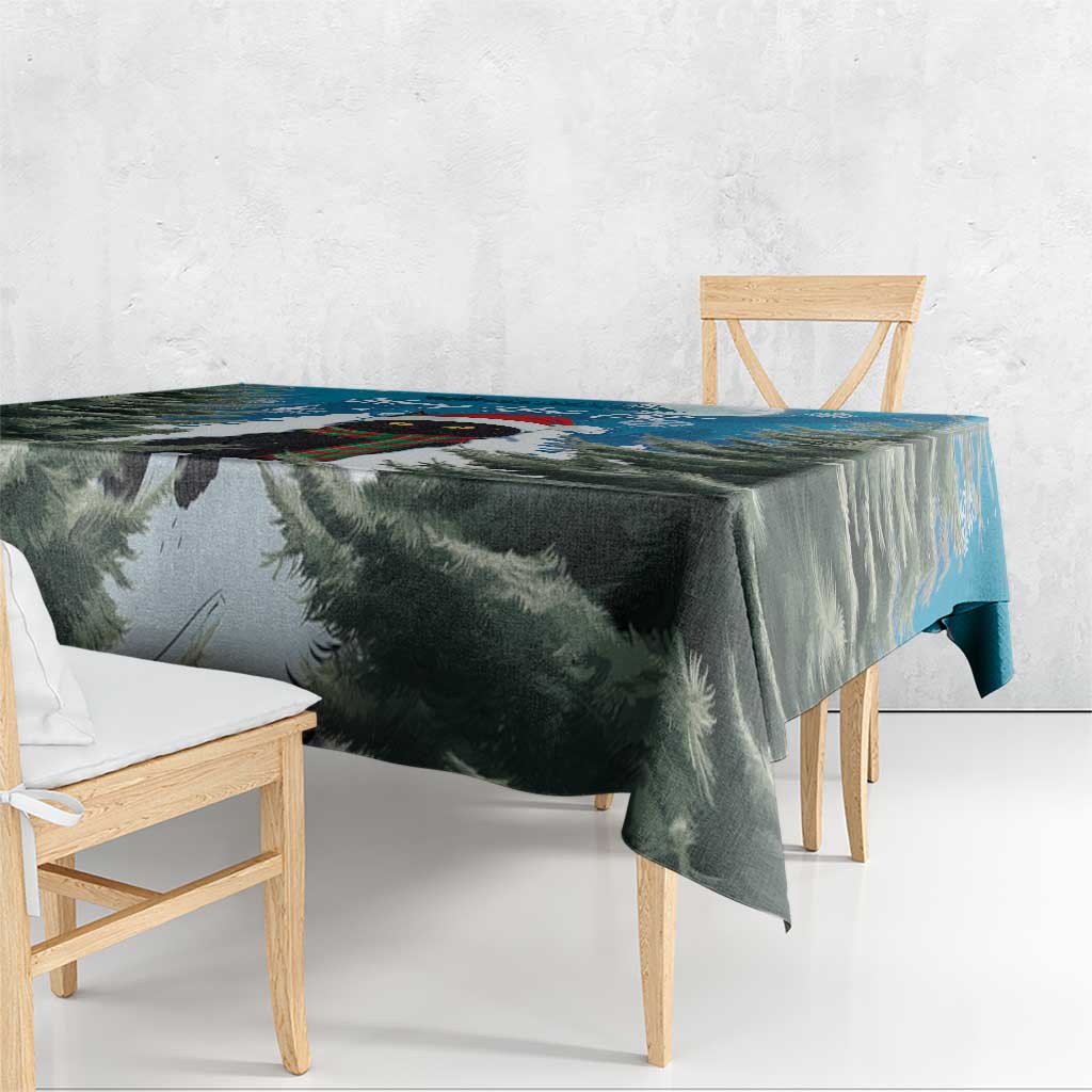 Blue and green Christmas tablecloth with fir branch print, hanging over table edge