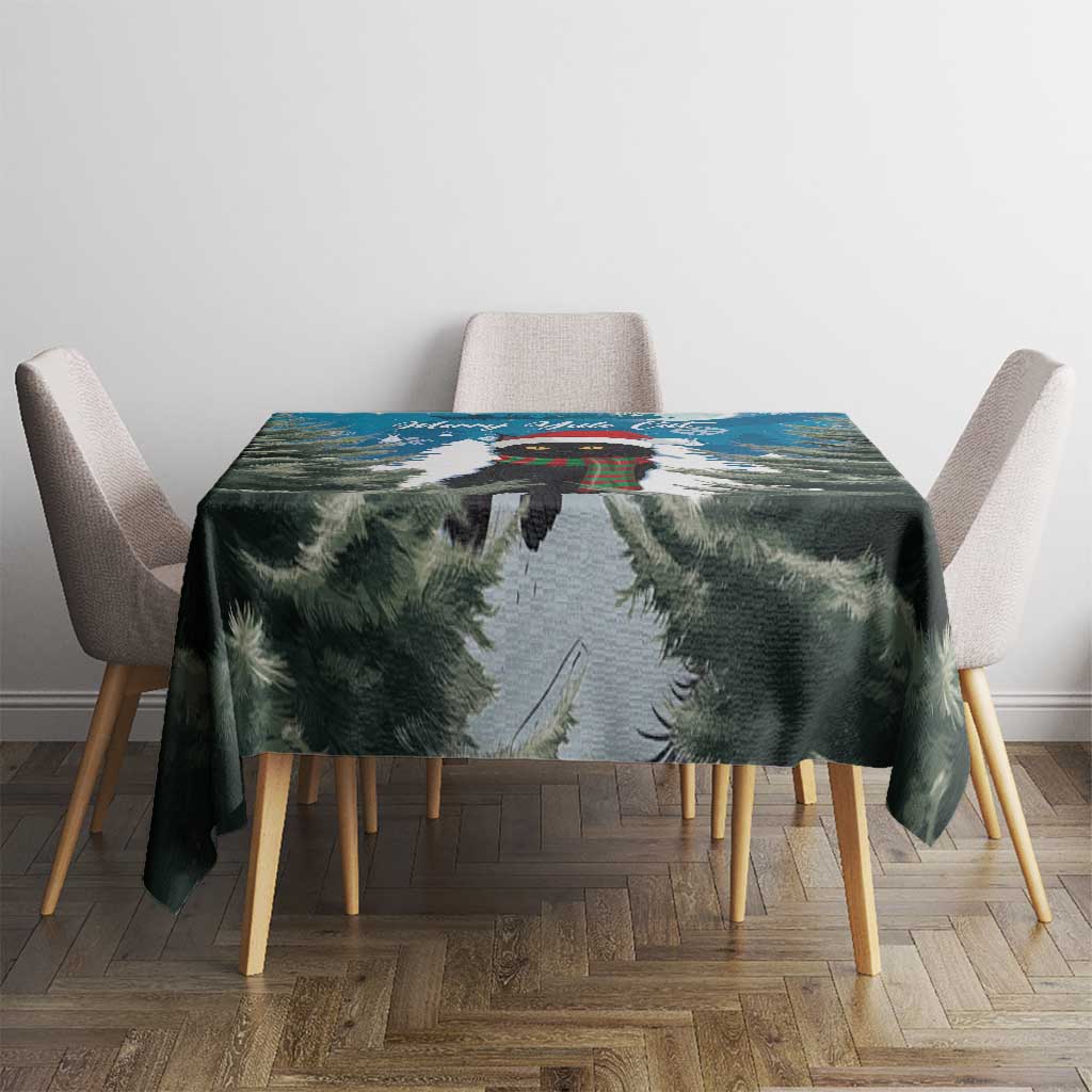 Blue Christmas tablecloth with fir branches and snow scene, centered on dining table